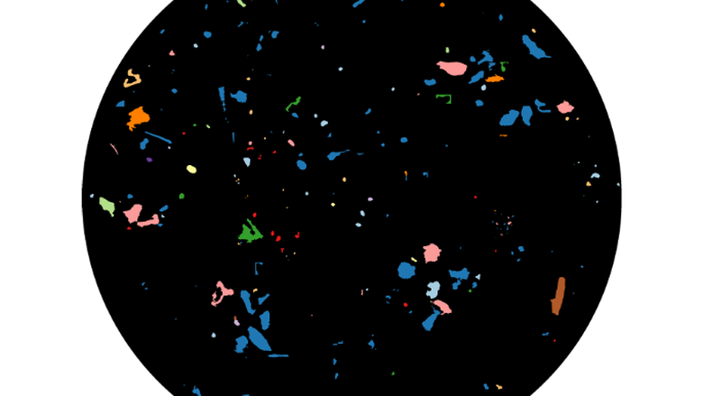 An LDIR image that shows the size, shape, and material characterizations of scanned microplastics that are between 10-990 um (microns).